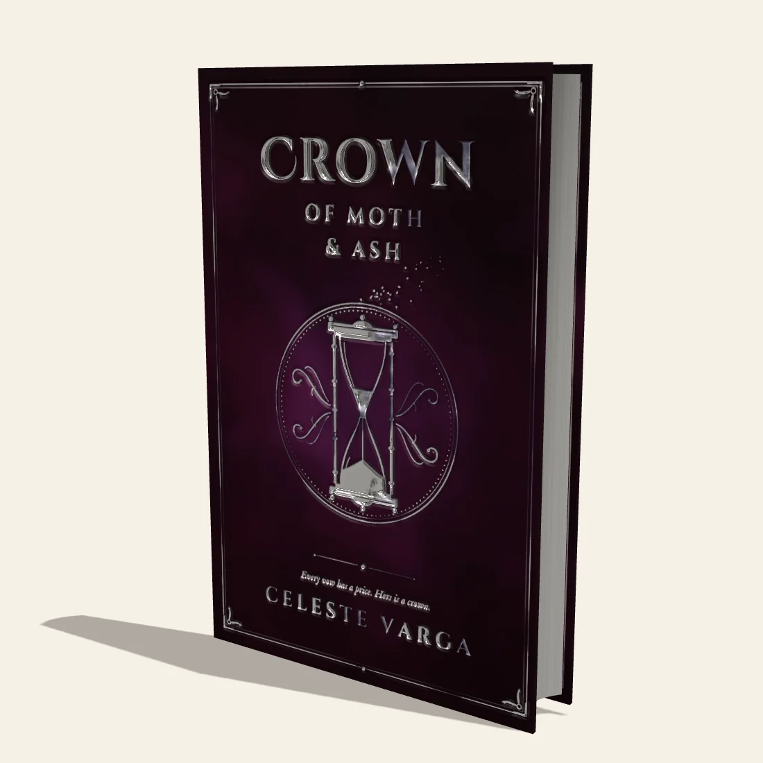 Crown of Moth & Ash, a plum hardcover with a rounded spine, silver foil and silver gilded edges