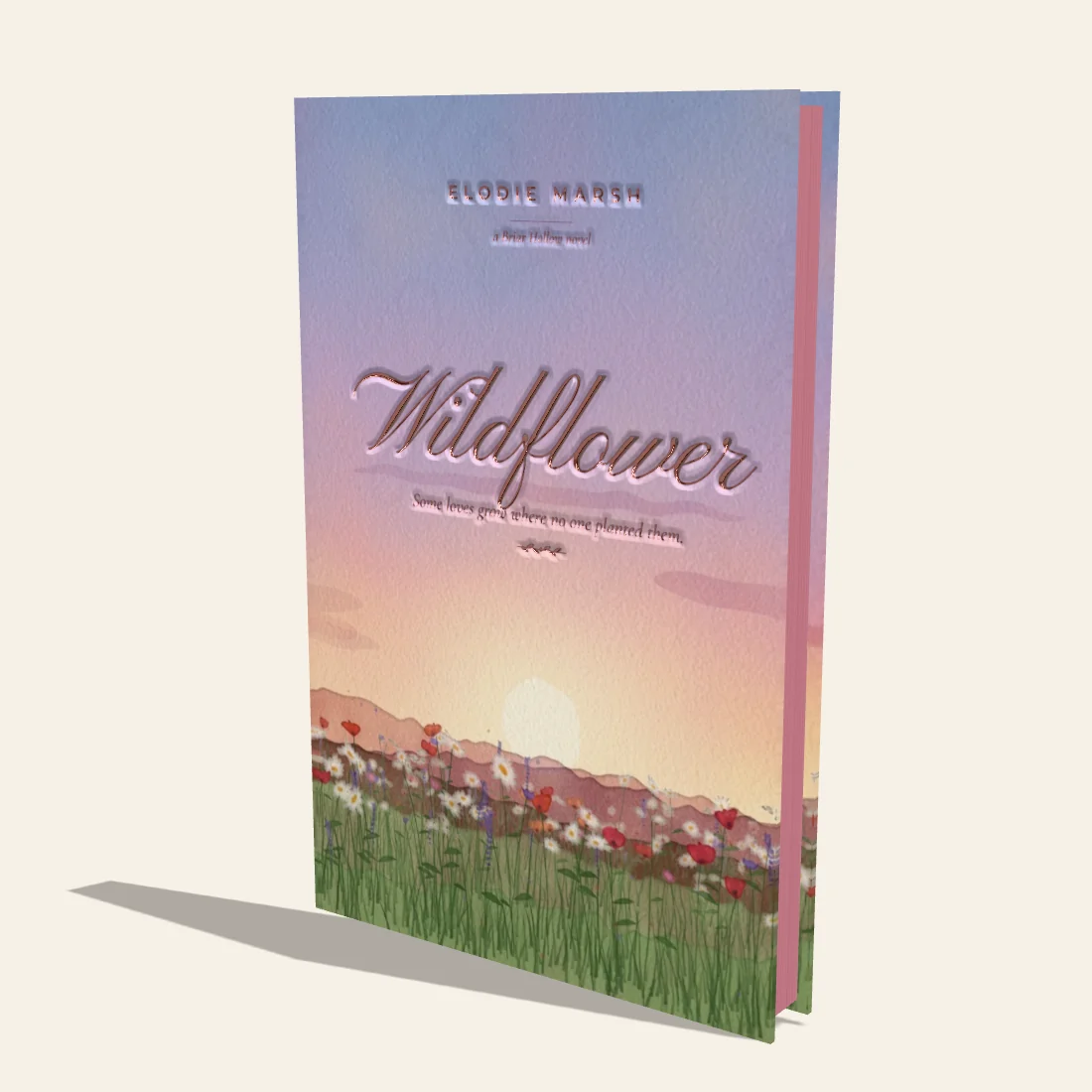 Wildflower, a cream hardcover painted with wildflowers, with a rose gold foil title and rose sprayed edges